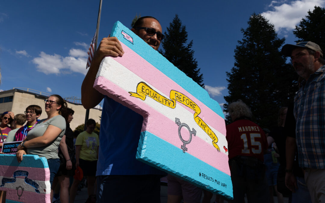 People rally in support of trans rights outside the Nebraska State Capitol Building on Sunday